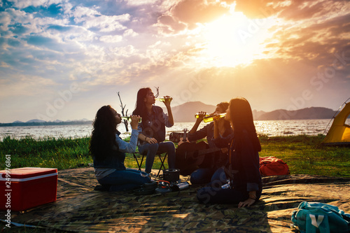 Canvas Print Group of Asian women party with drink bottles enjoy travel camping,trekking in vacation time at sunset