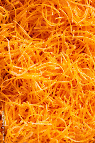 Bright orange fresh grated carrot background, Top view. Ingrediend. Vegetable. Close up. Healthy. Texture