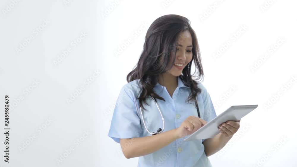 happy young asian smiling nurse using tablet pc happy young asian smiling nurse using tablet pc