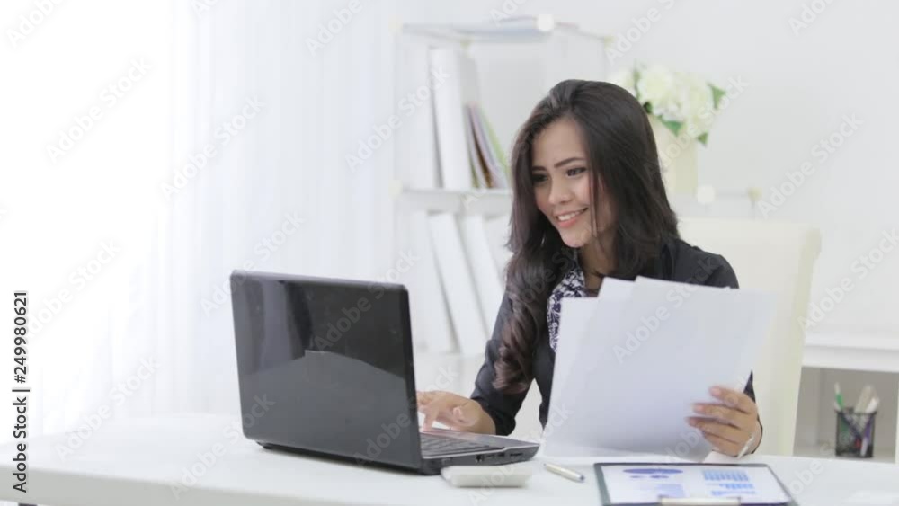 busy asian businesswoman while working in her office busy asian businesswoman while working in her office