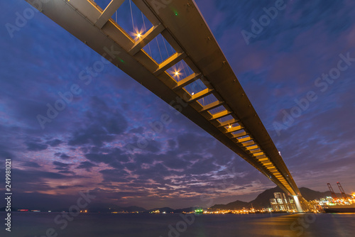 Cutterstone bridge and cargo port in Hong Kong city at dusk