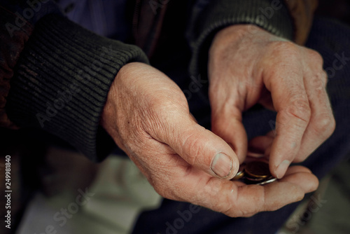Old hands count pennies. The concept of poverty, wage arrears.Concept Sanction poverty in Russia.