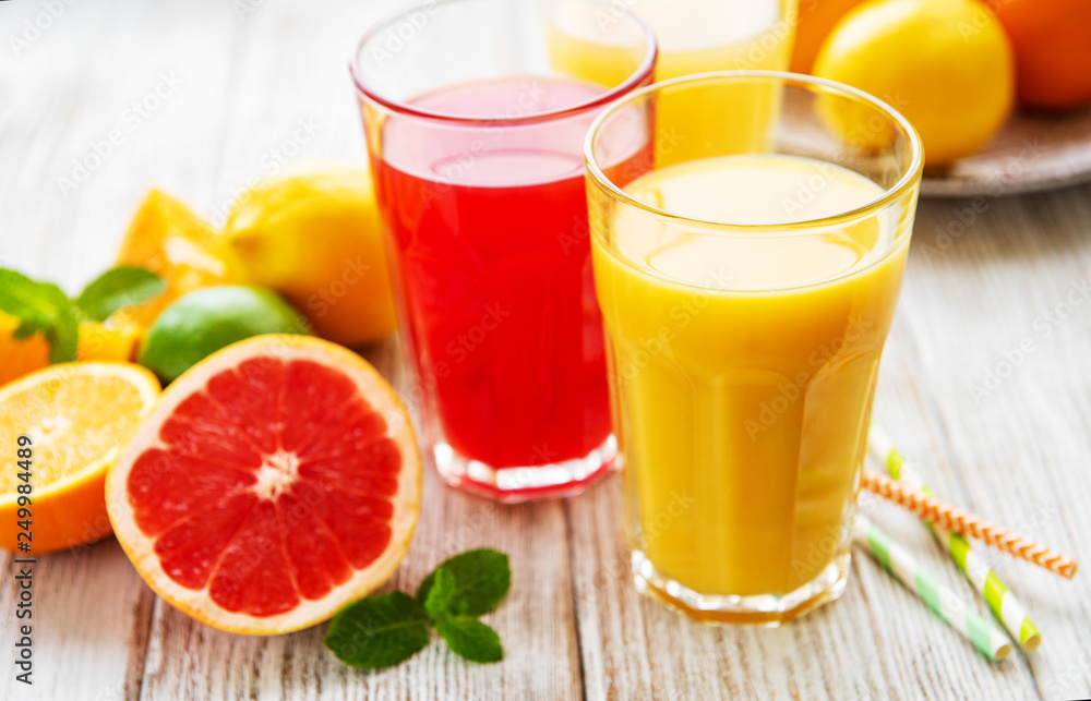 Glasses of juice and citrus fruits Glasses of juice and citrus fruits