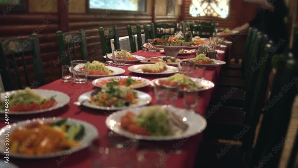 waitress puts plates with food on the table in restaurant or cafe, catering waitress puts plates with food on the table in restaurant or cafe, catering