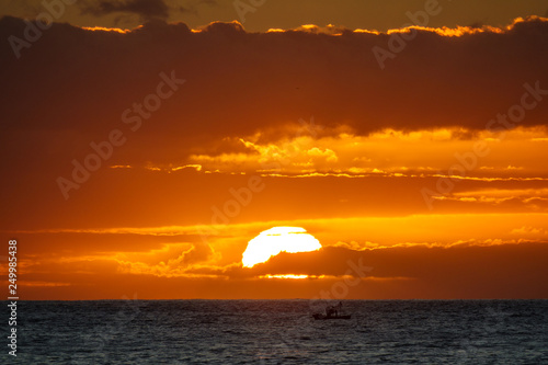 Fototapeta Naklejka Na Ścianę i Meble -  Sunset in the ocean with fishing boat