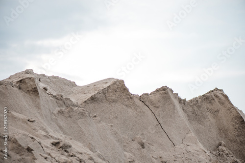 Large piles of construction sand and gravel used for asphalt production and building. Limestone quarry, mining rocks and stones 