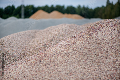Large piles of construction sand and gravel used for asphalt production and building. Limestone quarry, mining rocks and stones 