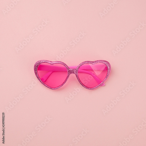 summer vacation monochrome concept. Heart shaped pink sunglasses on pastel pink background, flat lay, minimal concept. Time to travel, relax, holiday, valentine day, love concept © misskaterina
