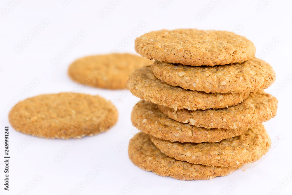 Homemade shortbread cookies made of oatmeal are stacked on a white table background. Food snack concept and with copy space for text. Homemade shortbread cookies made of oatmeal are stacked on a white table background. Food snack concept and with copy space for text.