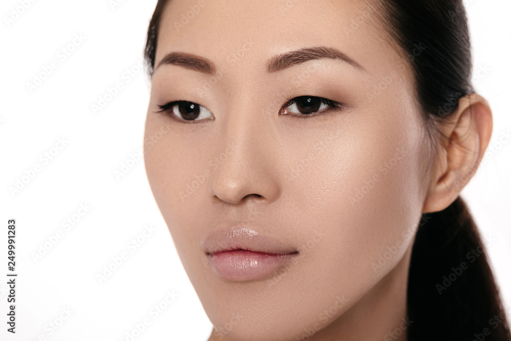 close-up portrait of beautiful young asian woman on white background closeup. girl with clean skin close-up portrait of beautiful young asian woman on white background closeup. girl with clean skin