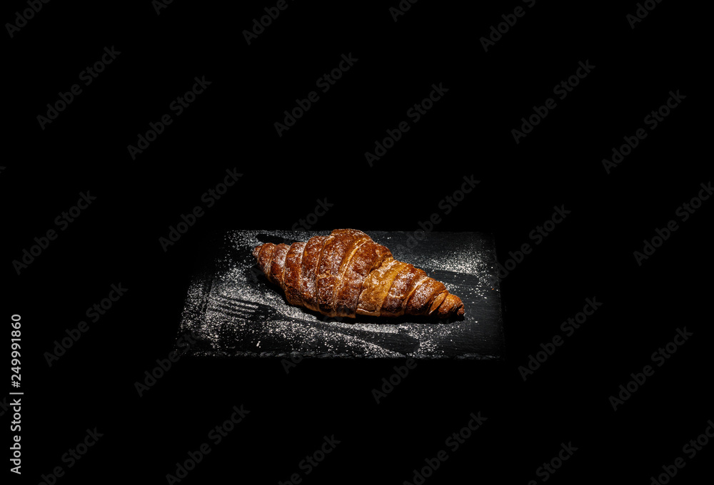 Freshly made croissant with remains of fork and knife