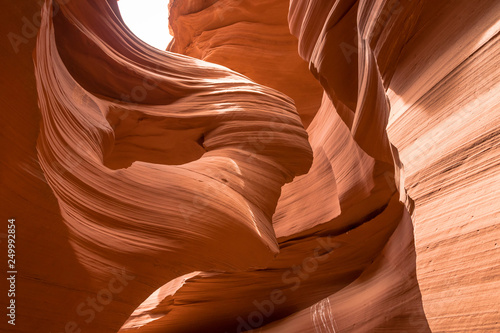 Lady with Hair Blowing in Wind at Antelope Canyon on Navajo land east of Page, Arizona. It is a slot canyon in the American Southwest. Lower Antelope has narrow slots and carved shoots.