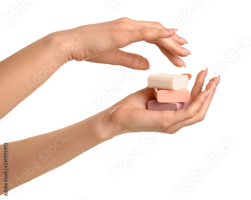 Female hands with soap bars on white background