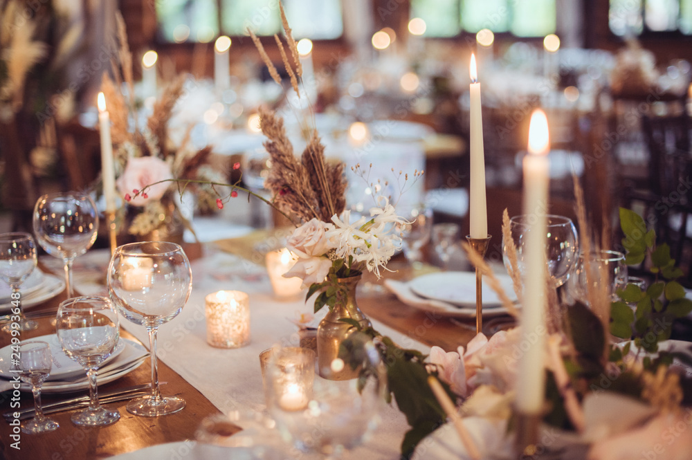rustic wedding decorations with flowers and candles. banquet decor. picture with soft focus - obrazy, fototapety, plakaty 