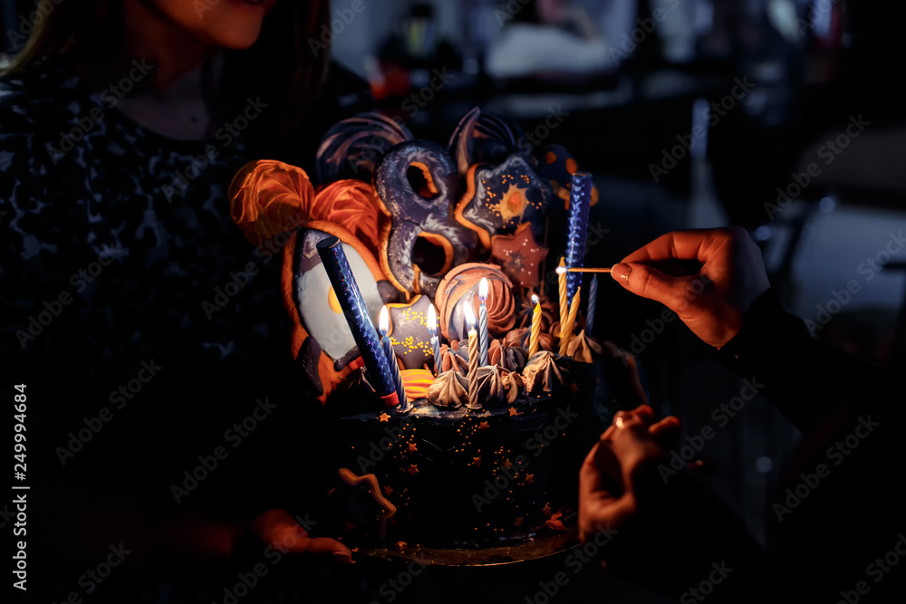 Lighting candles on birthday cake. 