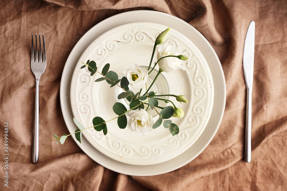 Simple table setting with floral decor Simple table setting with floral decor