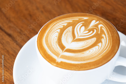 Coffee cup with latte art foam on wood table in coffee shop with copy space.Coffee is one of the most popular beverages.Improve Energy Levels and Burn Fat