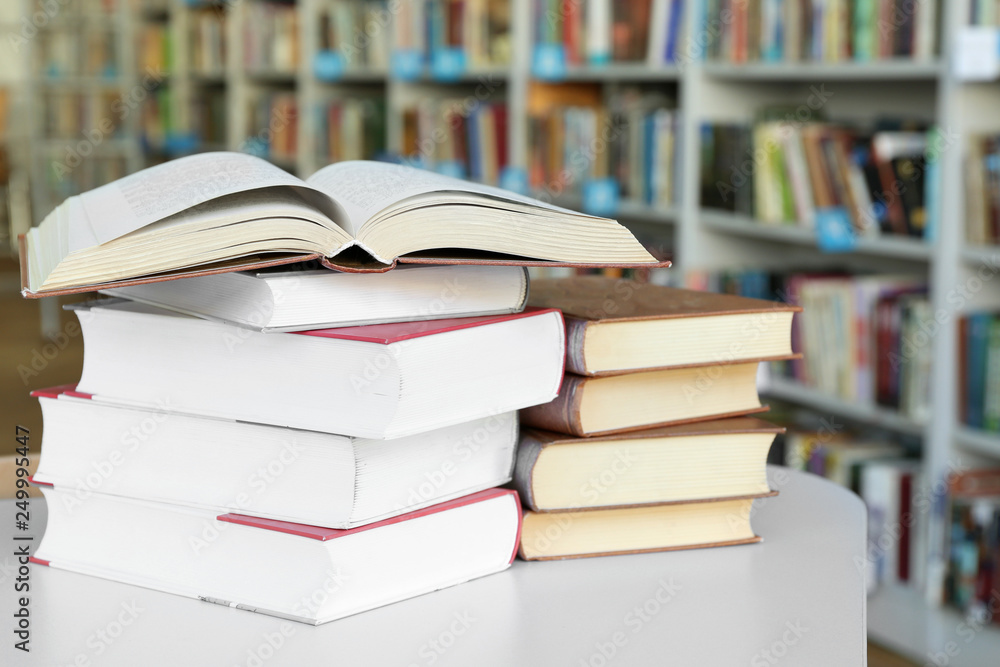 Many books on table in library Many books on table in library