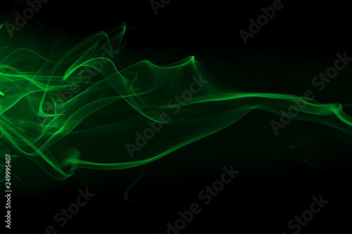 Movement of green smoke on black background for art design