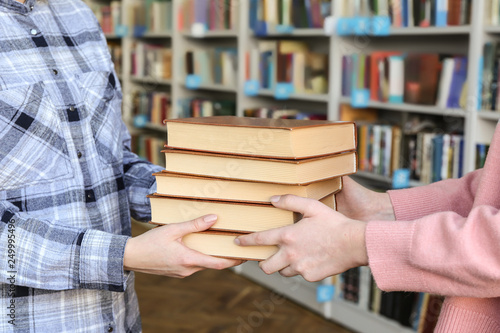 Young woman receiving books...