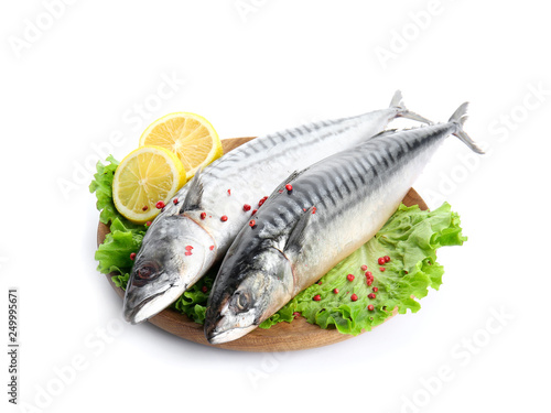 Wooden plate with tasty raw mackerel fish on white background