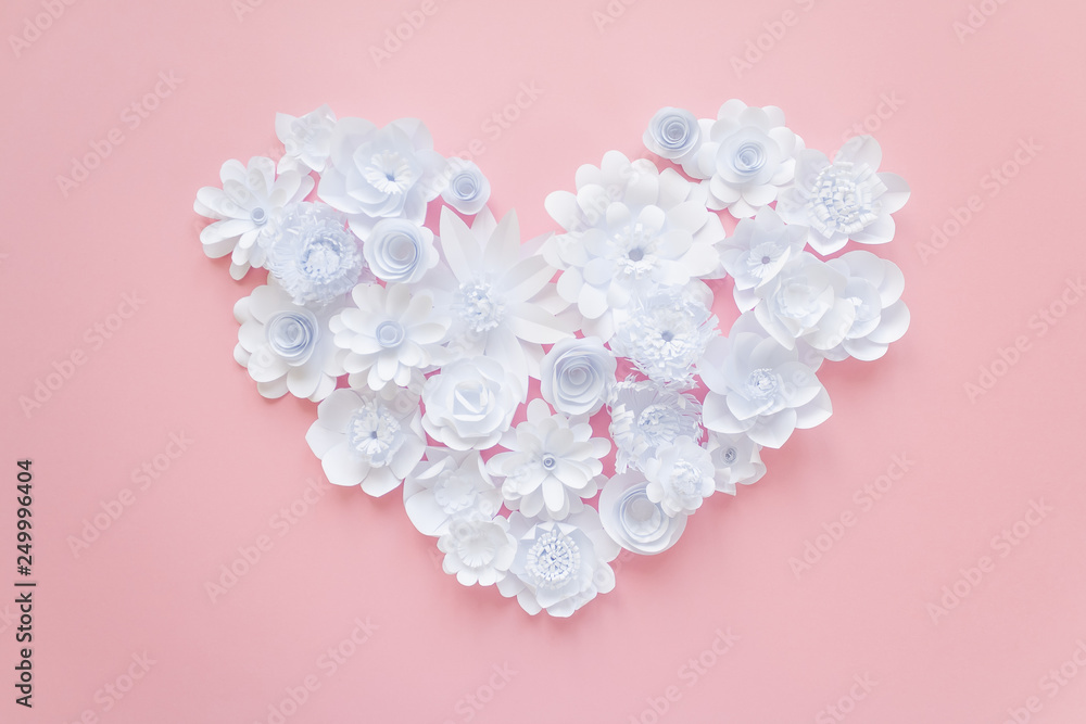 Heart from white paper flowers on pink background Heart from white paper flowers on pink background
