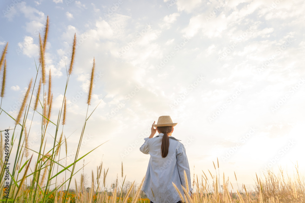 Girl wearing a hat Sitting looking at desho grass. Girl wearing a hat Sitting looking at desho grass.