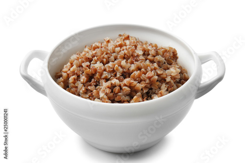 Pot with tasty boiled buckwheat on white background