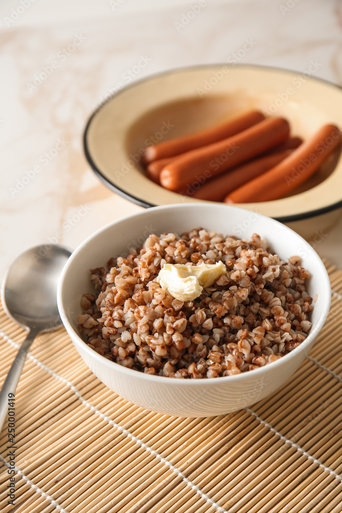 Bowl with tasty boiled buckwheat on table Bowl with tasty boiled buckwheat on table