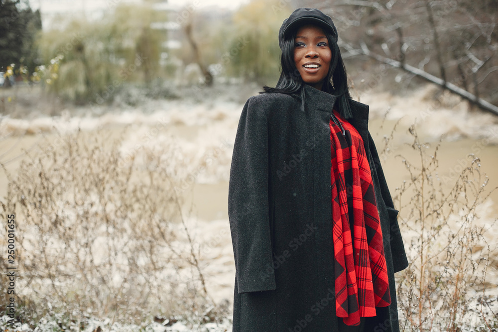 Elegant black girl in a winter park