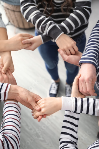 People holding hands together as symbol of support