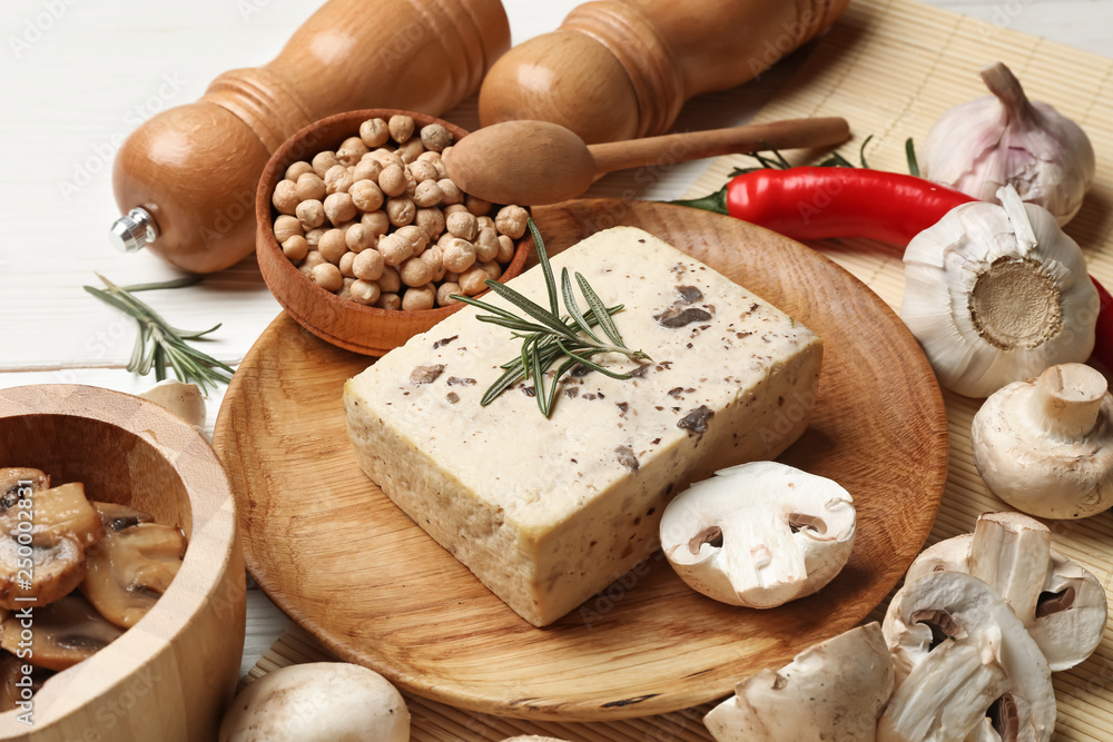 Plate with tasty tofu cheese and mushrooms on table Plate with tasty tofu cheese and mushrooms on table