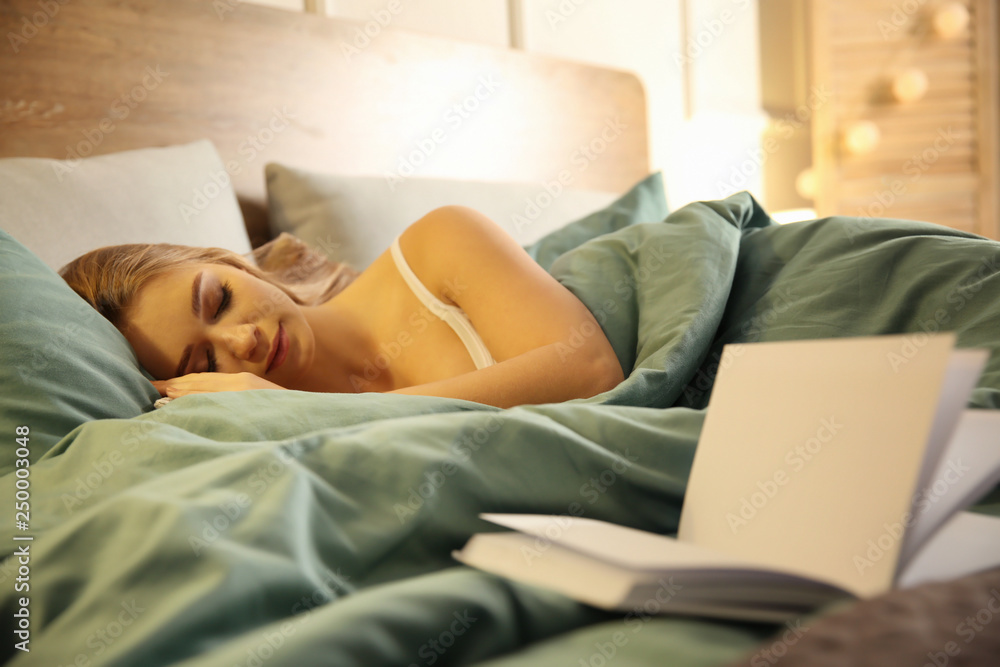 Book on bed of sleeping young woman Book on bed of sleeping young woman