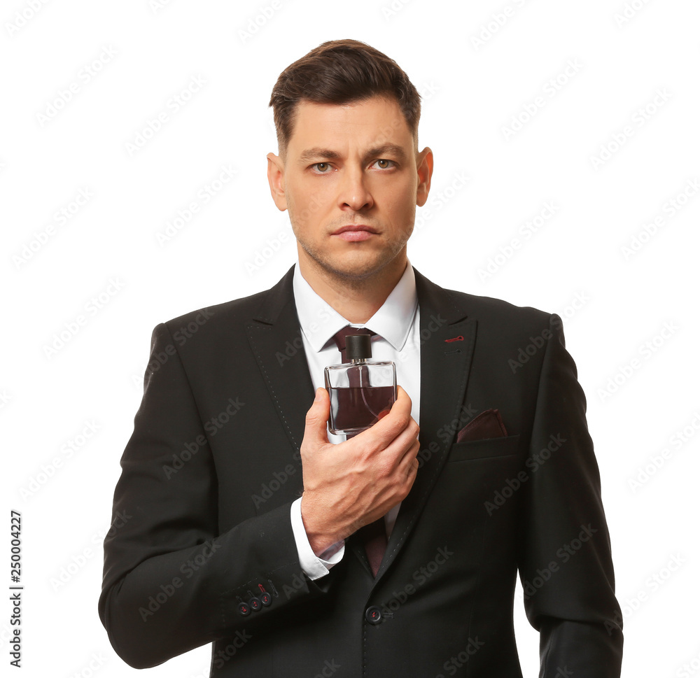 Handsome businessman with bottle of perfume on white background Handsome businessman with bottle of perfume on white background