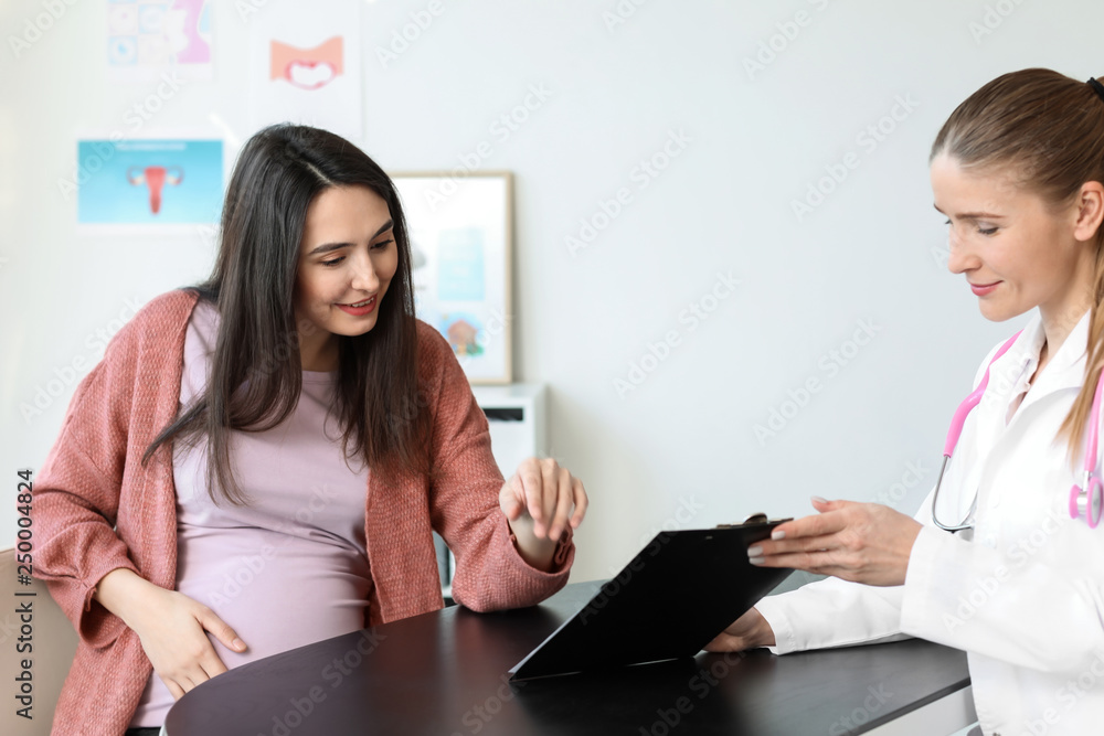 Beautiful pregnant woman visiting her doctor in hospital Beautiful pregnant woman visiting her doctor in hospital