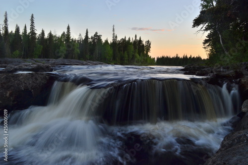 Waterfall on the river on a long exposure against the sunset