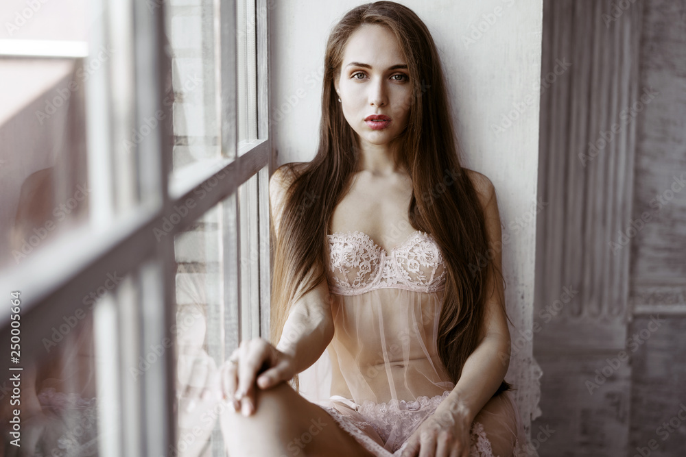 Fashionable female portrait of cute lady in pink robe and panties indoors Fashionable female portrait of cute lady in pink robe and panties indoors
