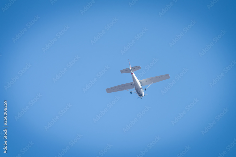A small white plane flying in the sky A small white plane flying in the sky