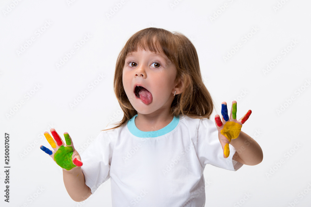 Happy smiling beautiful little girl with her colorful hands in the paint isolated on white background