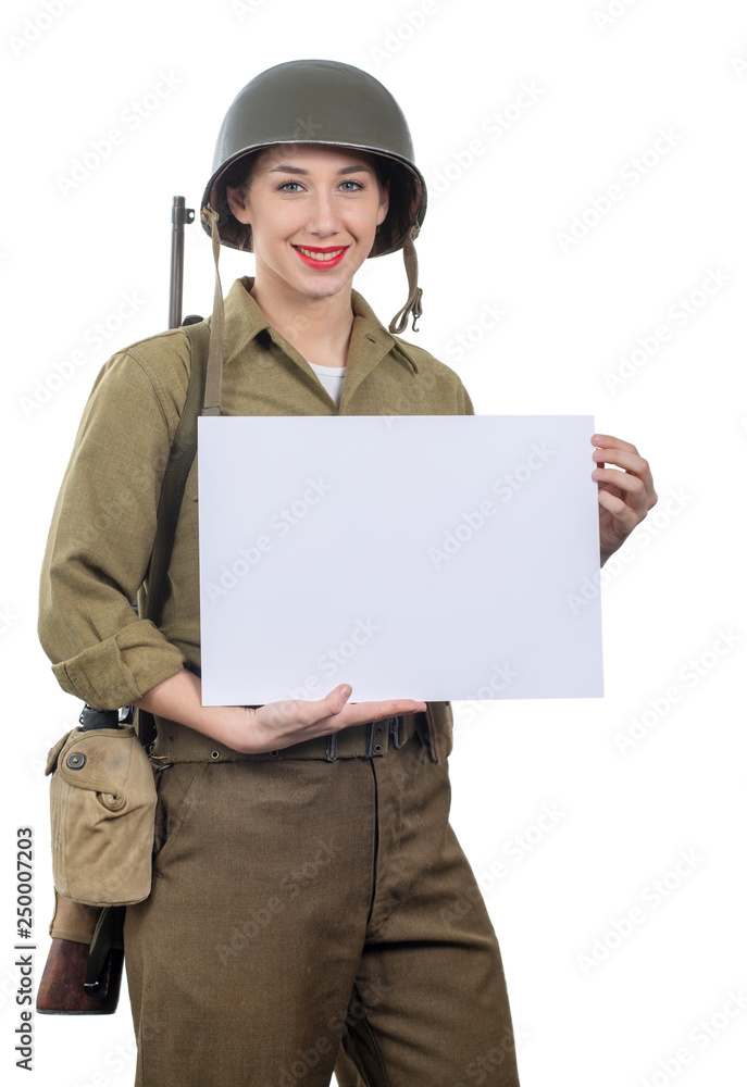 young woman dressed in wwii military uniform with helmet showing empty blank signboard with copyspace young woman dressed in wwii military uniform with helmet showing empty blank signboard with copyspace