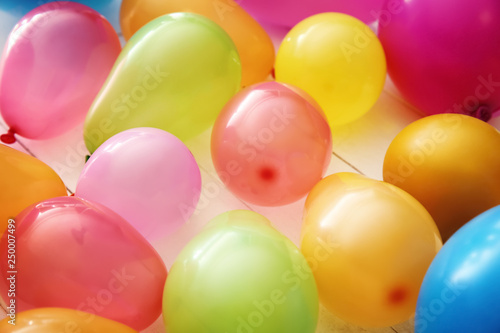 Colorful balloons on white wooden background © Pixel-Shot