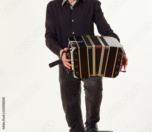 GOMEL, BELARUS - FEBRUARY 14, 2019: a bandoneon musical instrument in the hands of a musician. photo