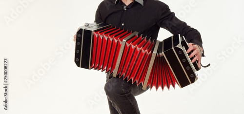 GOMEL, BELARUS - FEBRUARY 14, 2019: a bandoneon musical instrument in the hands of a musician. photo