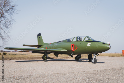 Big old green jet plane parked on the runway