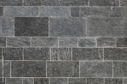Black stone wall background, High quality gray stone paving with light mortar