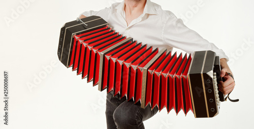 Photos GOMEL, BELARUS - FEBRUARY 14, 2019: a bandoneon musical instrument in the hands of a musician