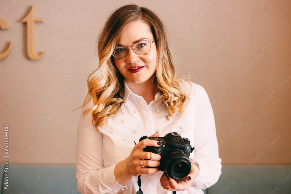 Candid portrait of beautiful blonde girl woman photographer with her camera at work Candid portrait of beautiful blonde girl woman photographer with her camera at work