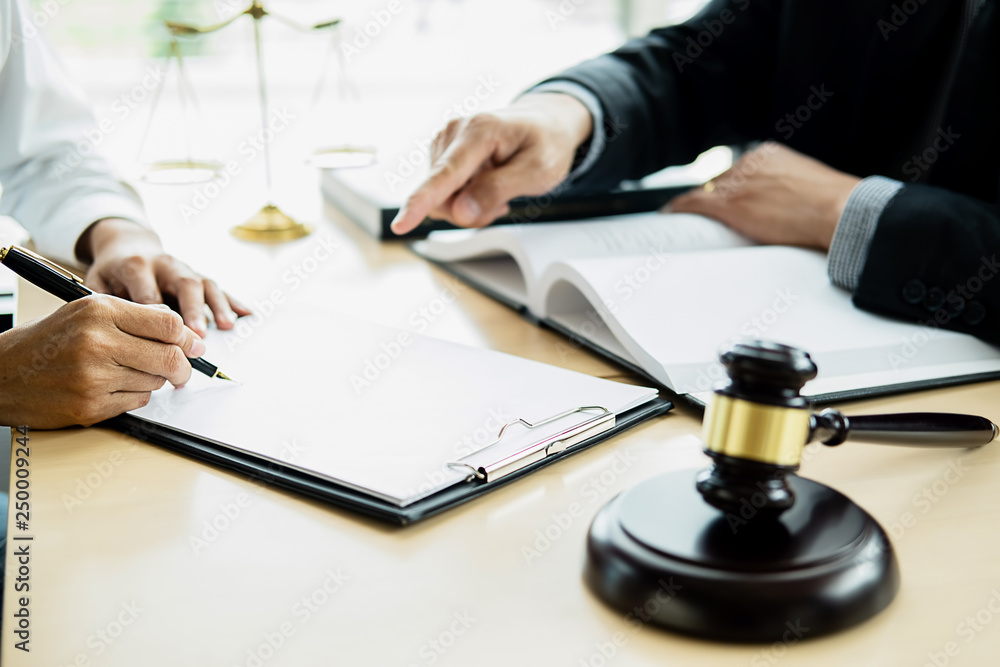 Judge gavel with Justice lawyer having team meeting at law firm with legal office background. Concepts of Law and Legal services Judge gavel with Justice lawyer having team meeting at law firm with legal office background. Concepts of Law and Legal services