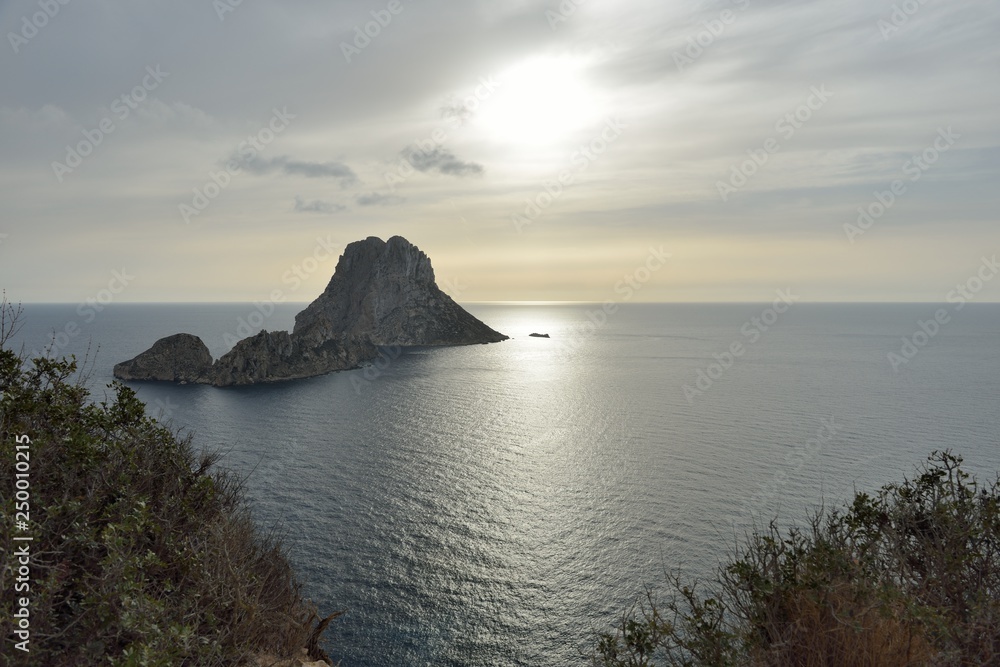Picturesque view of the mysterious island of Es Vedra. Ibiza, Balearic Islands. Spain Picturesque view of the mysterious island of Es Vedra. Ibiza, Balearic Islands. Spain