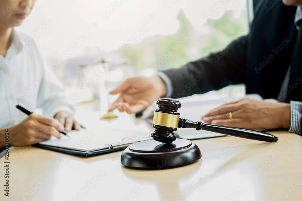 Judge gavel with Justice lawyer having team meeting at law firm with legal office background. Concepts of Law and Legal services Judge gavel with Justice lawyer having team meeting at law firm with legal office background. Concepts of Law and Legal services